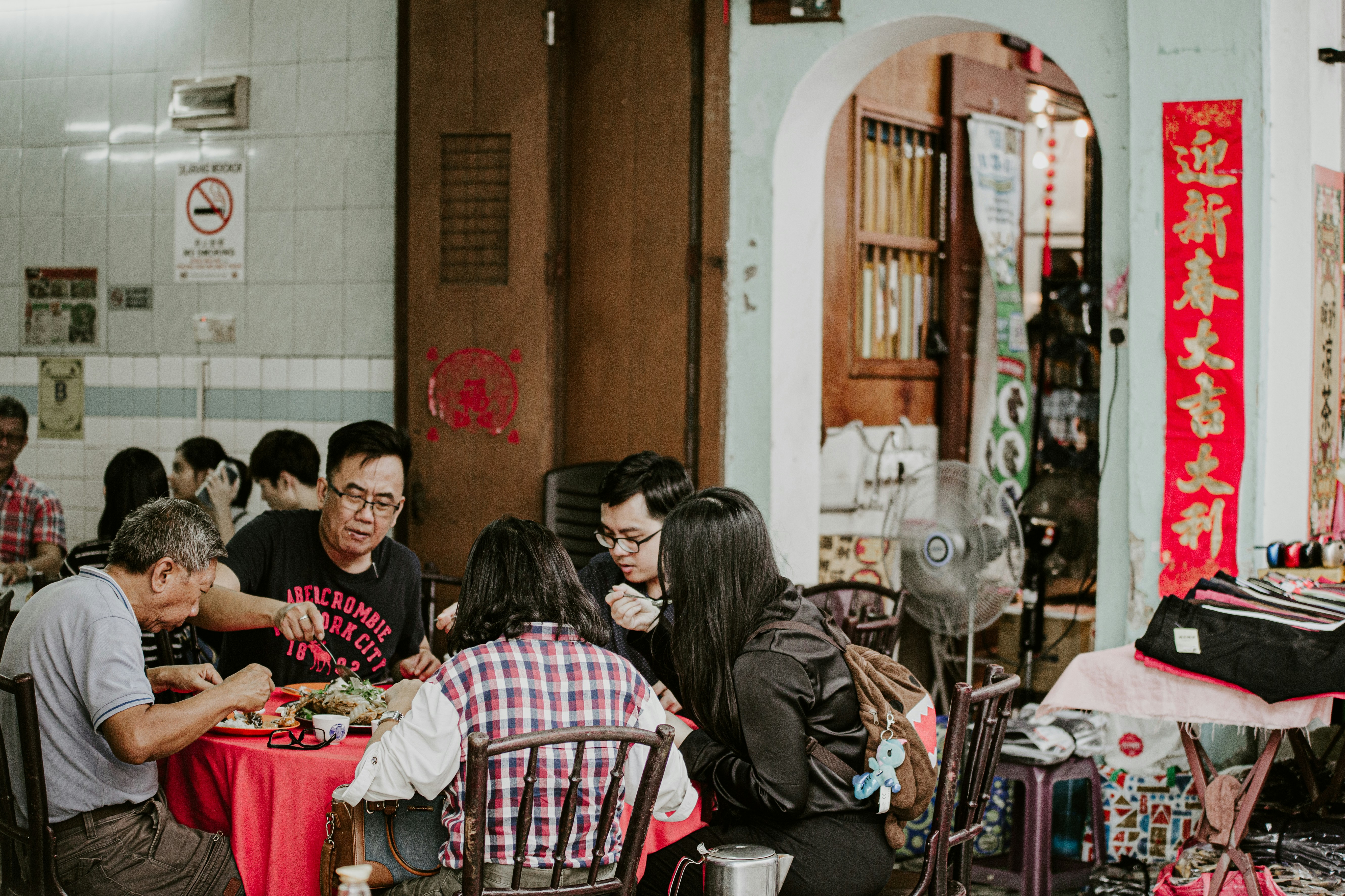 Families and friends enjoying a meal together at a local Chinatown restaurant