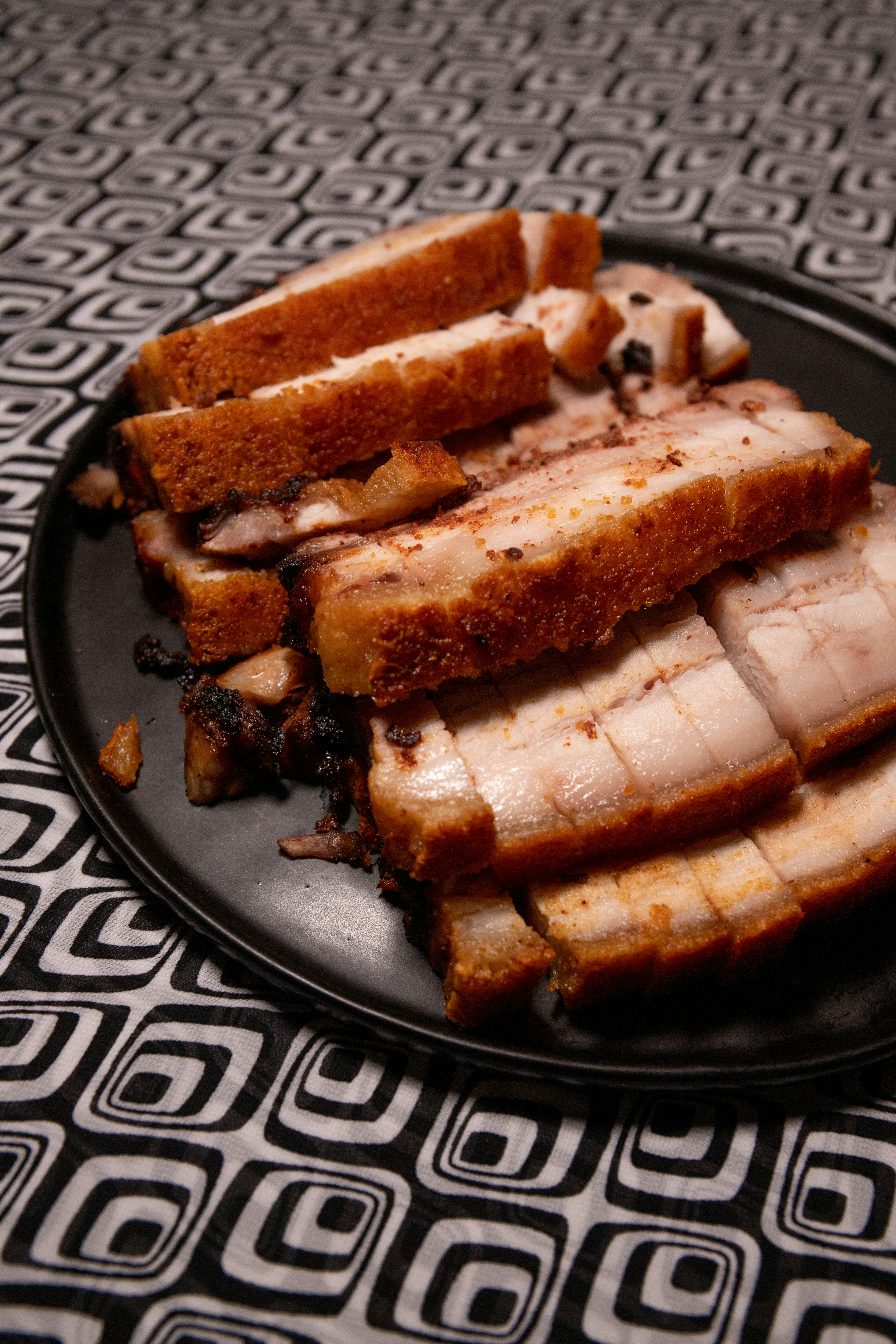 Crispy pork belly with crackling skin served on a plate